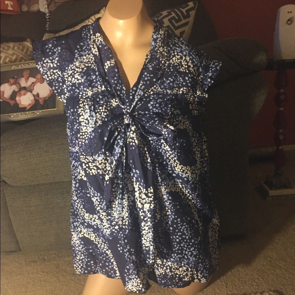 Sleeveless, button up dress top with tie.